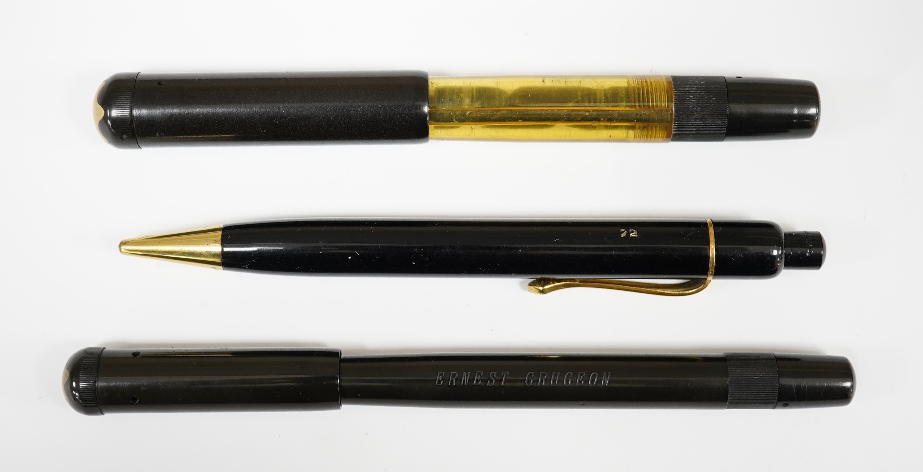 Montblanc safety fountain pens, one with clear celluloid barrel (damaged), a Montblanc pencil and another Montblanc safety pen